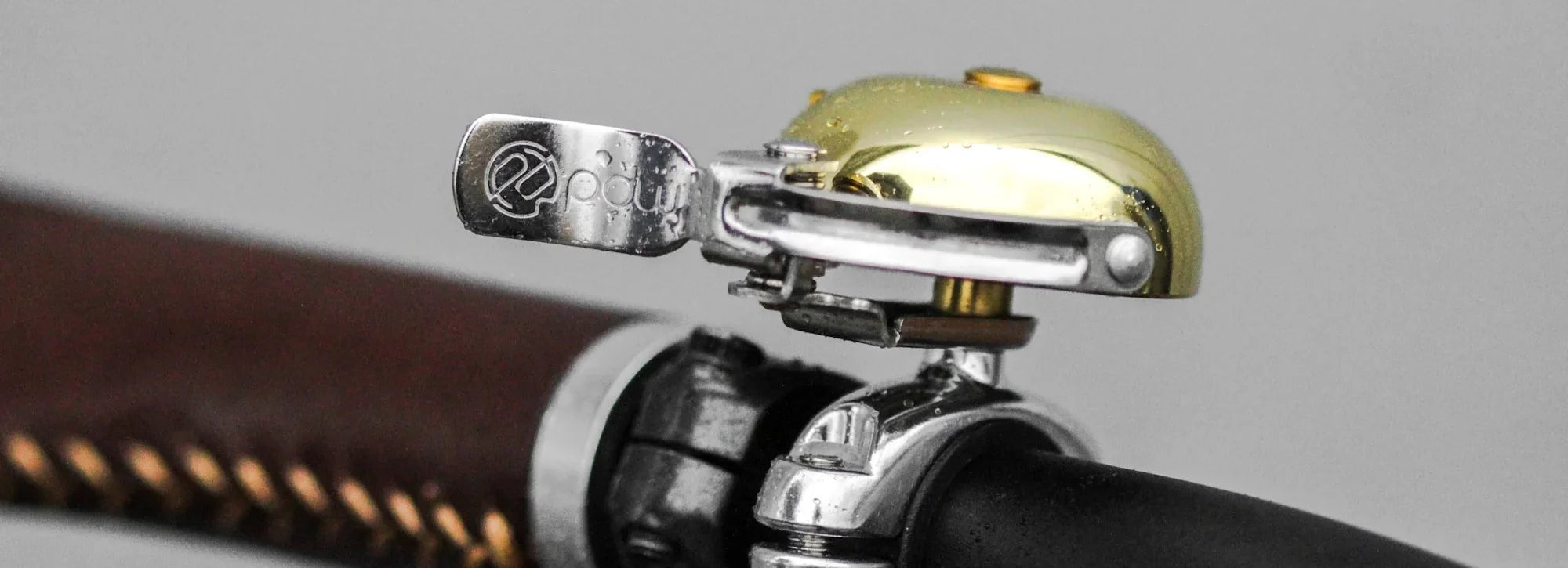 King of Ding brass bell on handlebars with leather grip in the background