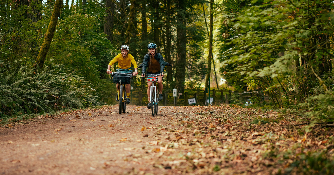 Two bicycle riders on a gravel trail